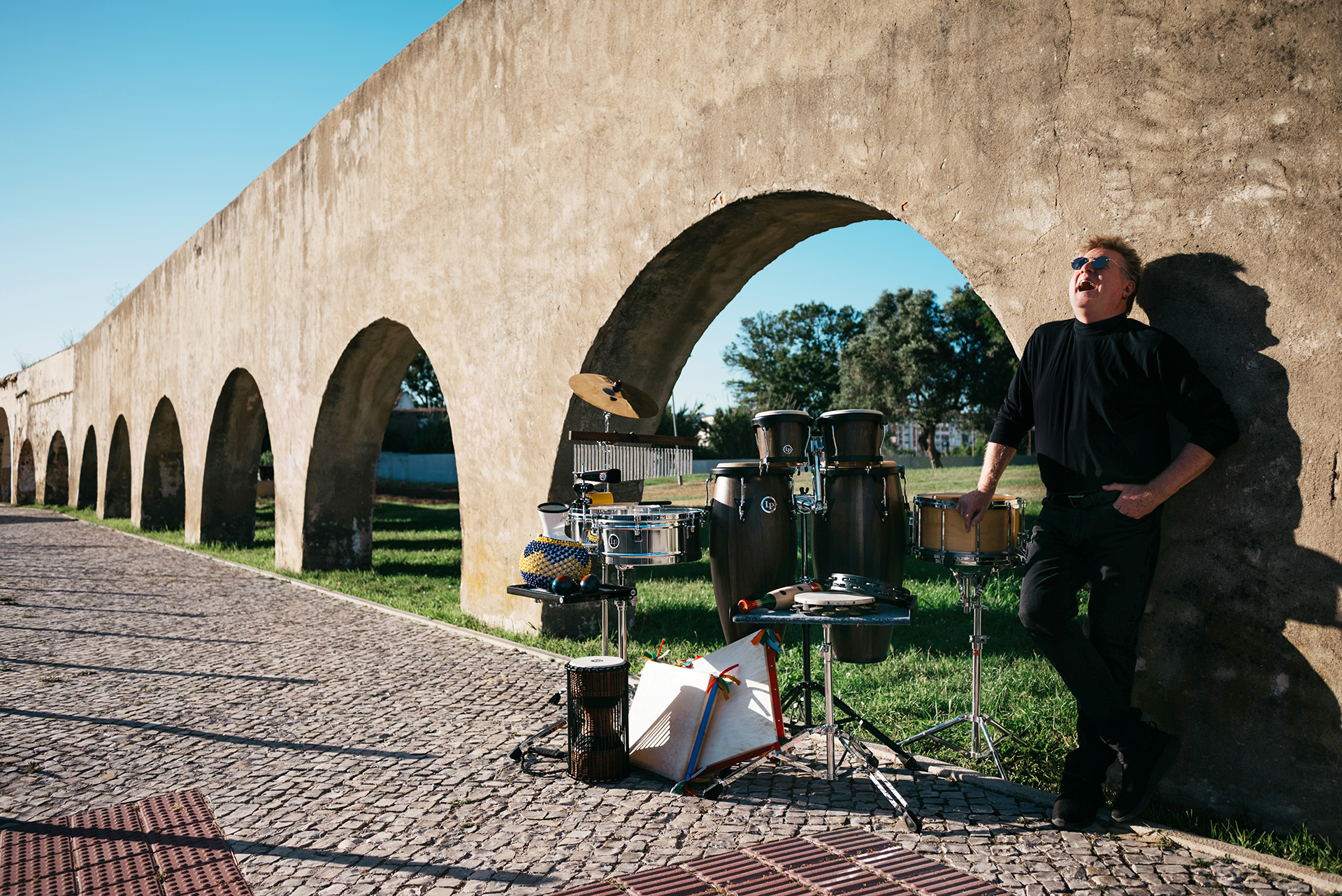 Brian laughing with percussion setup by the 15th-century Setúbal aquaduct
